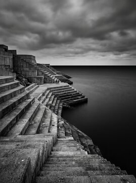 Brutalist Concrete Seascape Stairs Under Dramatic Storm Clouds