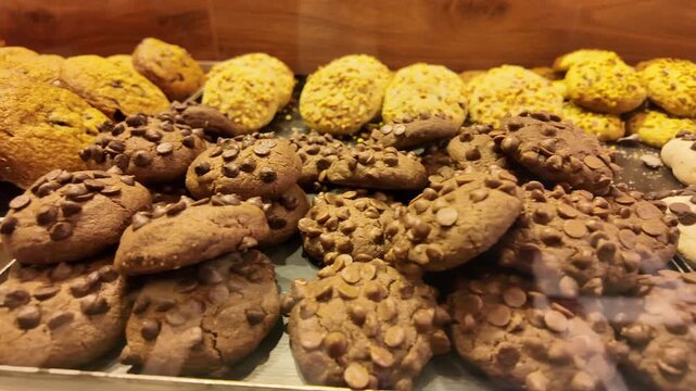 Cookies on display in a bakery window in the afternoon