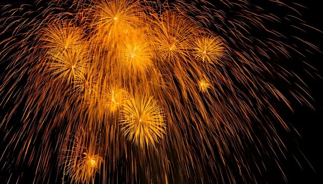 Brilliant golden fireworks explode against a stark black backdrop, showcasing trails of light in a celebratory burst