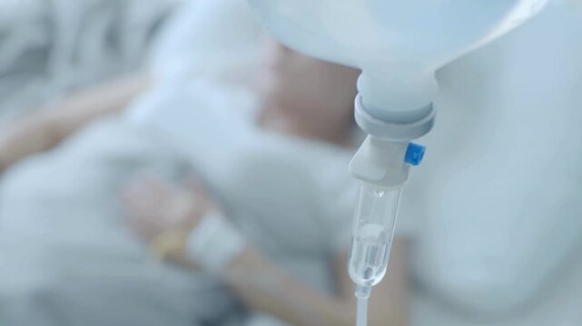Person, Pensive sad old woman lying on hospital bed looking trough the window get sick admitted to hospital with saline intravenous iv in-line hand