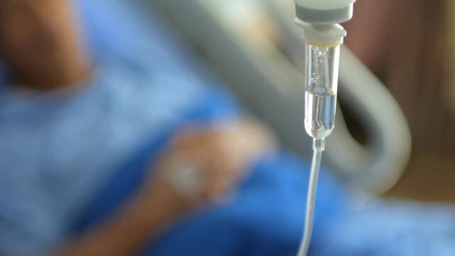 clinic give salt water on hospital bed elderly person hand with medical drip intravenous needle, Ill female patient with intravenous drip at hospital