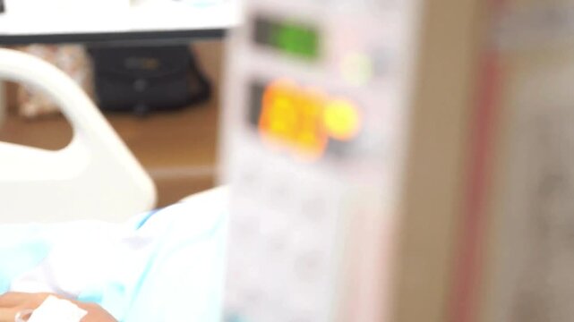 Asian elderly patient recovery after surgery in hospital icu and emergency or recovery Nurse sets directly into vein saline bottle iv drip background