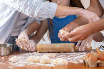 Fototapeta premium Father mother and daughter preparing homemade pastries.