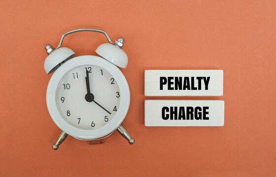 A coloured block with text PENALTY CHARGE next to white alarm clock. Representing the financial consequences of procrastination, late payments, or missed deadlines