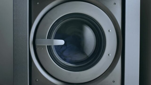person unloading and loading clean cloth after doing cleaning laundry in machine washer