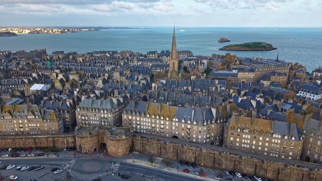 Saint Malo Intra Muros with La Grand' Porte gate and roundabout, Chauss&eacute;e du Sillon access road and parking, Saint Vincent Cathedral spire, Grand B&eacute; and Fort du Petit B&eacute;, drone ascent, France