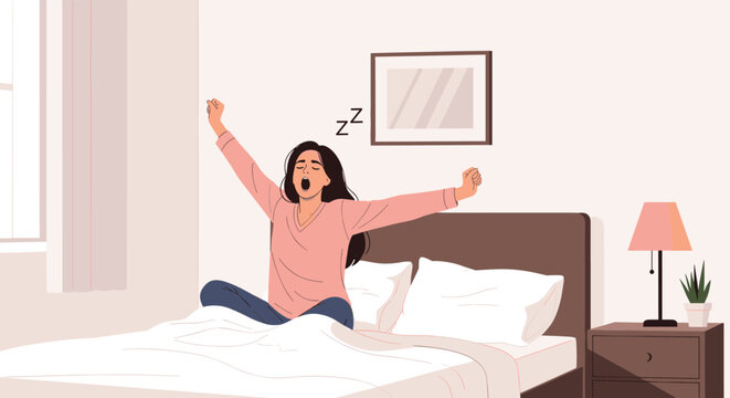 Tired young woman sitting in her comfortable bed yawning and stretching her arms after waking up in the morning.