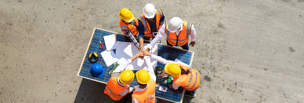 Ethnic diversity worker people, Success teamwork. Group of professional engineering people wearing hardhat safety helmet meeting with solar photovoltaic panels discussion in new project