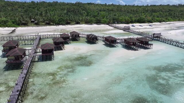 Berau, Indonesia, April15th, 2026 : Beautiful Overwater Bungalows in a Tropical Paradise with Crystal Clear Water