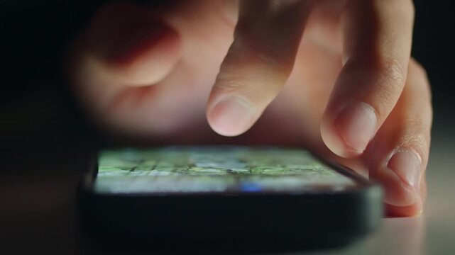 Smartphone user experience concept. Male hand scrolling interface shows intuitive design and comfort. Smartphone interaction in low light highlights ease of use modern apps and positive digital flow.