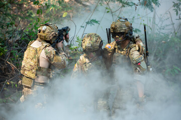 U.S. Army Soldiers Provide Tactical Support and Comfort to Fallen Comrade with Medical Assistance in Dense Forest Environment, Offering Emotional Support During Operational Duty. © AU USAnakul