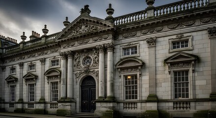 Obraz premium Dramatic Historic Baroque Style Civic Building with Heavy Columns, Sculpted Pediments, and Tall Windows, Shot Under Moody Evening Skies, Emphasizing Ornate Stonework, Dark Doorway, and the Grand, Somb
