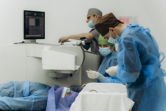 Medical team performing laser eye surgery on patient