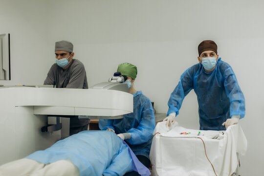 Medical team performing laser eye surgery on patient