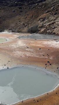 View of hot geothermal mud pots steaming at Krysuvik geothermal area, Reykjanes peninsula, Iceland