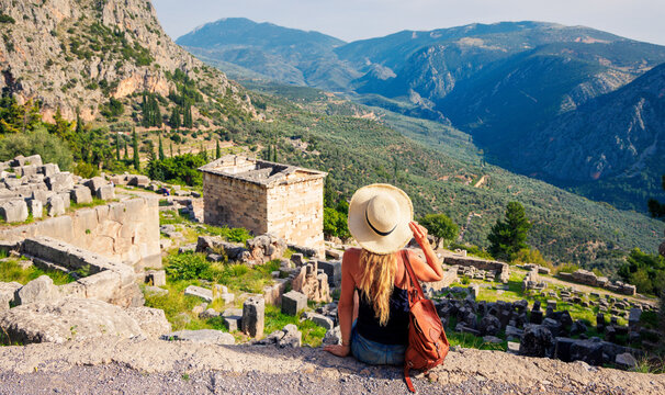 High Angle View of Woman Contemplating Ancient Ruins and Valley in Delphi Greece
