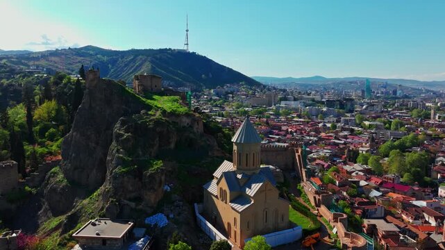 Aerial footage of Narikala Fortress in Georgia, capturing the medieval hilltop landmark and the expansive Tbilisi cityscape below.