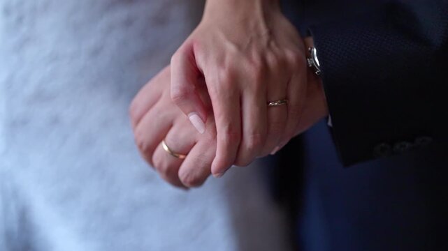 Close view of couple holding hands with love and commitment