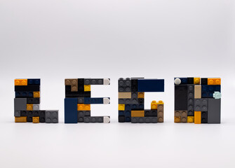 Naklejka premium Bologna - Italy - April 14, 2026: The word LEGO spelled out using various colorful plastic building blocks on white background.