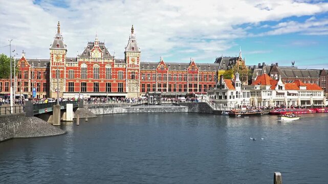 Historic Central Station Building With Canal And Tourist Boats