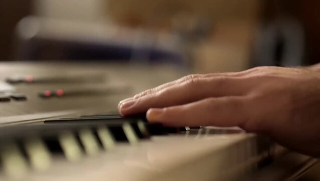 close up hands playing keyboard piano