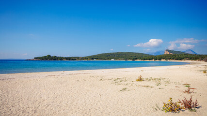 Obraz premium Empty Sandy Beach with Turquoise Water and Blue Sky in Peloponnese Greece