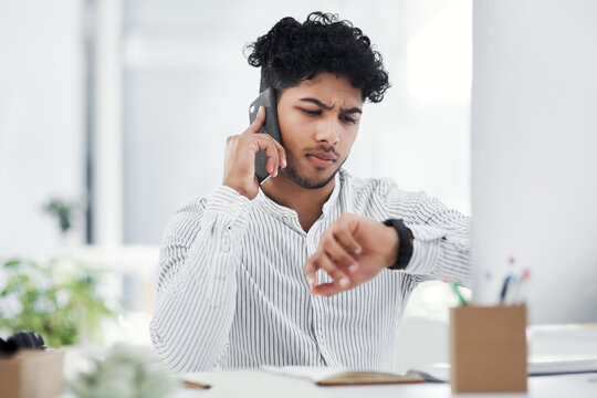 Computer, phone call and watch with business man at desk in office for deadline or schedule. Checking time, delay and feedback with employee person in workplace for planning, setback or update