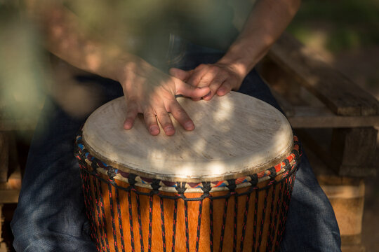 Playing at djembe drum outdoor, having a good time. Rythm and sound