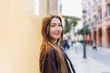 Fototapeta premium Young woman smiling in urban street lifestyle