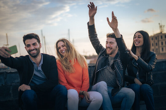 Celebrating friendship and connection in an urban setting, captured in a candid moment at sunset.