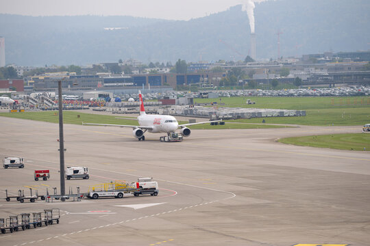 Swiss passenger airplane Airbus A320-214 registration HB-IJR pushback at Swiss Z&uuml;rich Airport on a gray autumn day. Photo taken October 3rd, 2025, Zurich Airport, Switzerland.