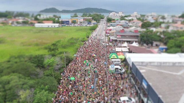 Aerial view of the street block carnival named Samambloco on the street of the town of Campeche, Florianopolis, Brazil