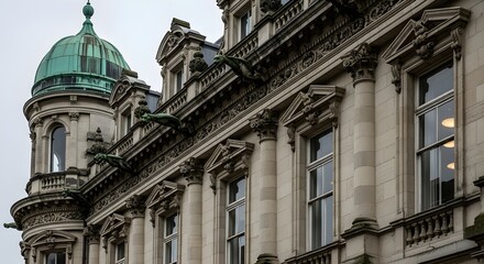 Obraz premium Elegant Stone Facade of a Historic Corner Building with Green Copper Dome, Repeating Classical Columns, Tall Windows, and Rich Cornice Detailing, Representing Refined Nineteenth Century European Urban