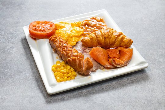 Hearty breakfast plate with sausage croissant