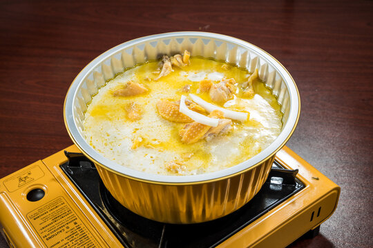 Rich chicken broth simmering on tabletop stove