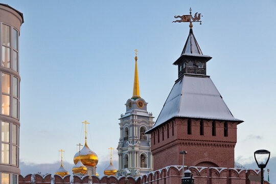 Golden domes glow against clear blue sky