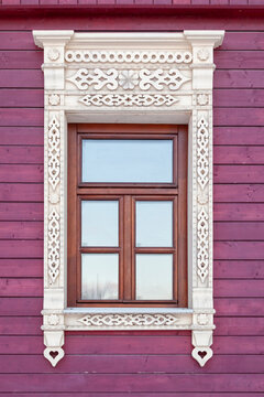 Elegant carved wood frames grace a vibrant purple wall