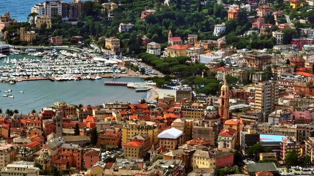 Aerial telezoom of Rapallo harbor and vibrant coastal homes in Liguria, Italy