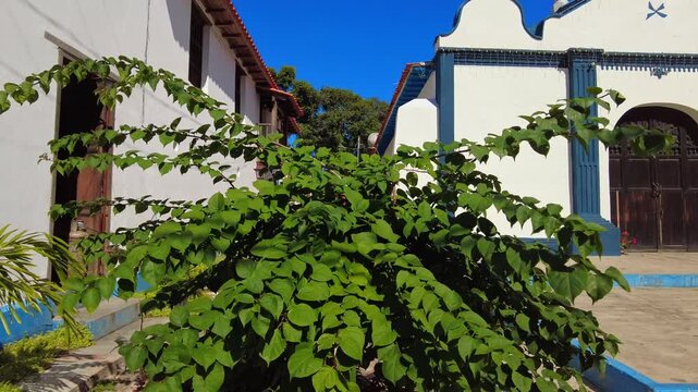 Panoramic view of the sign depicting the Virgin of Belen, patron saint of Aragua, and the Church of Santa Clara de Asis in Choroni, Aragua, Venezuela