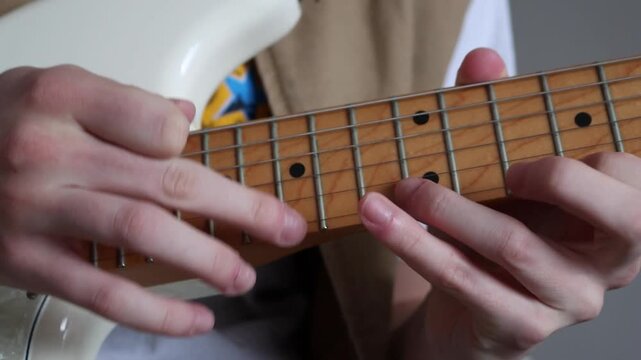 A person using the tapping technique on an electric guitar