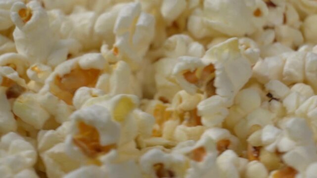 Macro shot of rotating fluffy popcorn pile texture