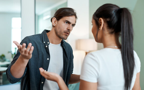 Argument, tension and couple in living room with fight, conflict or frustration in toxic relationship. Angry, man or woman in house with disagreement, confrontation or mistake in marriage crisis.