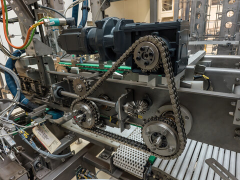 Servomotor with a gearbox and a chain inside a machine.