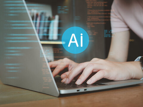 Person typing on laptop keyboard with AI code overlay conveying technology innovation and focused work