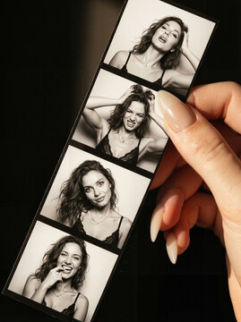 Young woman posing playfully in photo booth black-and-white strip  