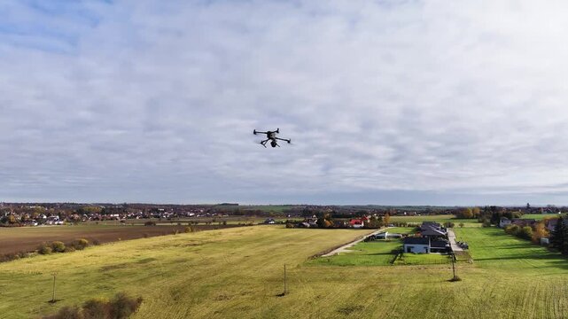 High-tech drone with LiDAR scanner doing an autonomous mission over a rural area