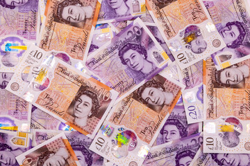 Obraz premium A background with many 20 and 10 pound banknotes, british currency, Elizabeth II