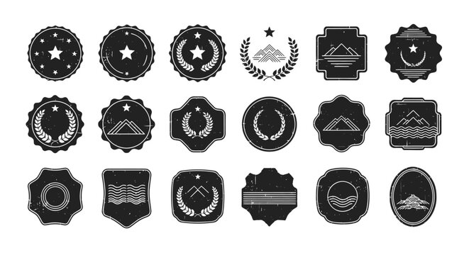 Collection of various black metal badges.