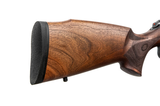 Detailed view of a wooden rifle buttstock with a rubber recoil pad isolated on a white back