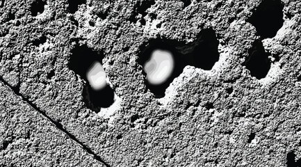Abstract textured surface with dark craters and light highlights © S.Siam